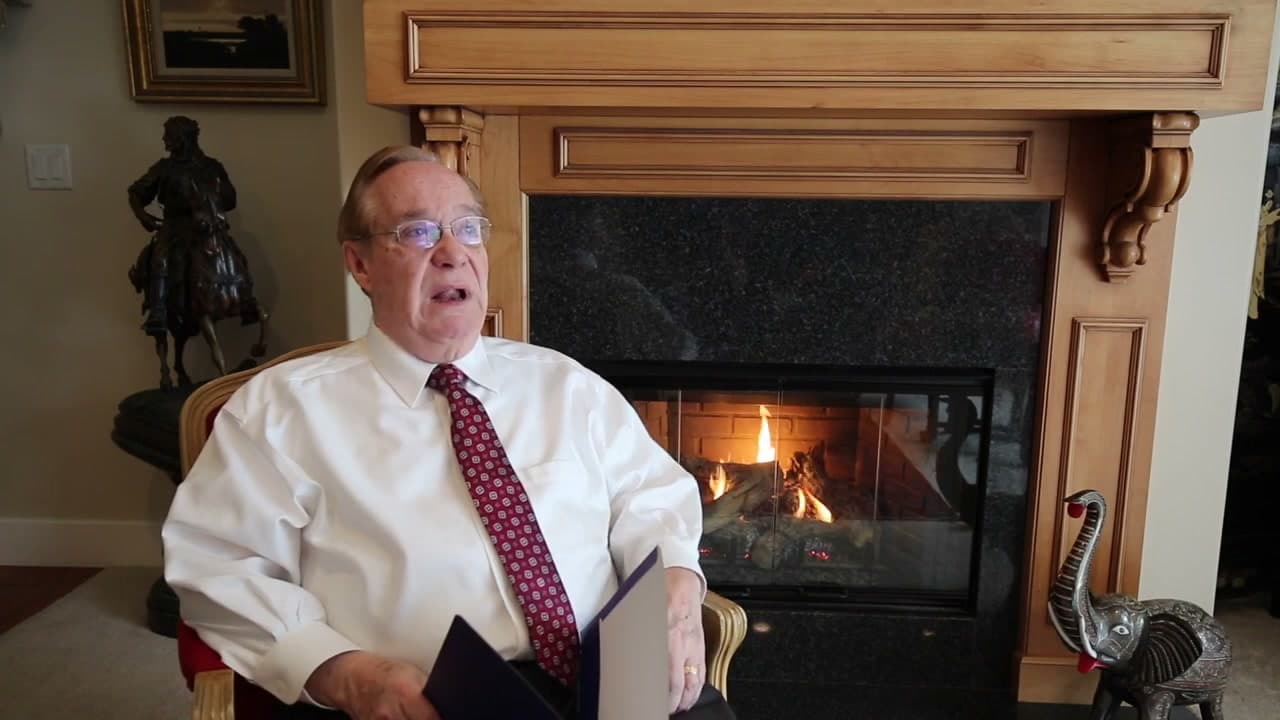 Jerry seated beside a fireplace during his 2016 life-story interview