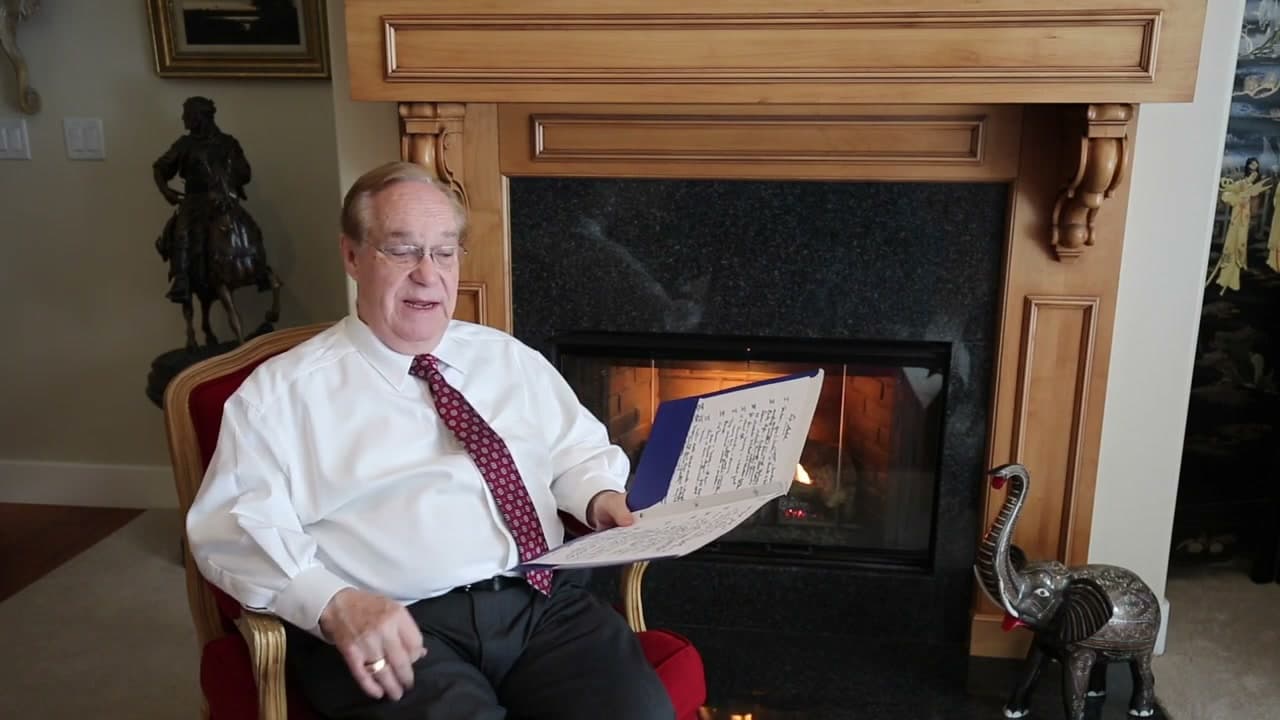 Jerry holding his interview notes in front of the fireplace